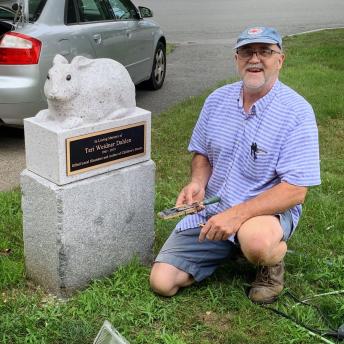 Thomas Berger, sculptor, with sculpture after installing plaque.